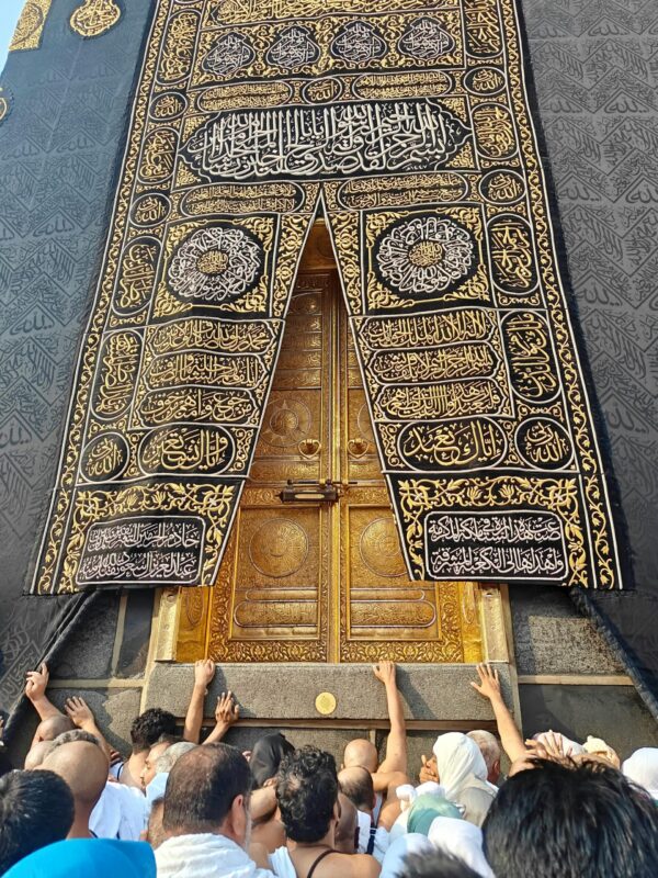 Devout pilgrims reach for the golden door of the Kaaba at Masjid al-Haram in Mecca, Saudi Arabia.