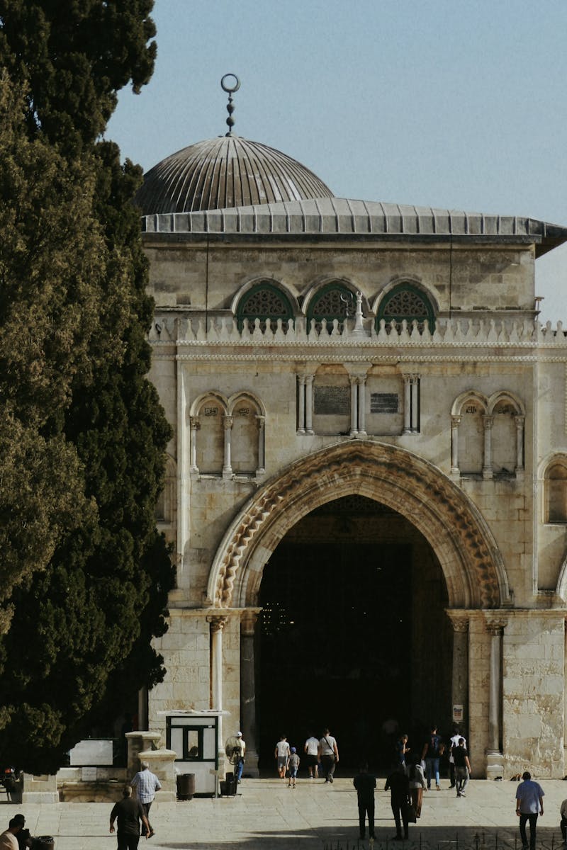 Stunning view of Al-Aqsa Mosque entrance with people walking in Jerusalem.