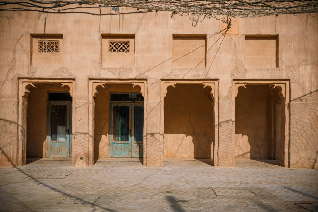 Traditional architecture in Al Fahidi District, Dubai with rustic sandstone walls.