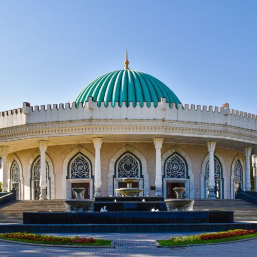 Beautiful exterior of the Amir Timur Museum featuring a striking turquoise dome in Tashkent, Uzbekistan.