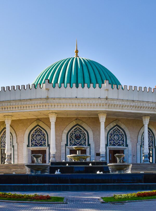 Beautiful exterior of the Amir Timur Museum featuring a striking turquoise dome in Tashkent, Uzbekistan.