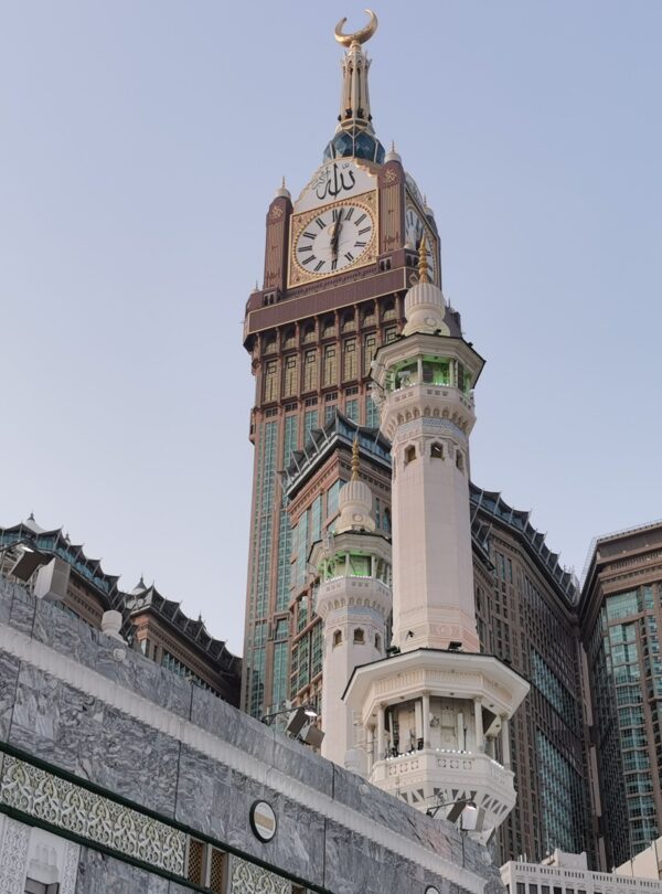 View of the iconic Abraj Al Bait and Mecca Clock Tower with surrounding architecture.