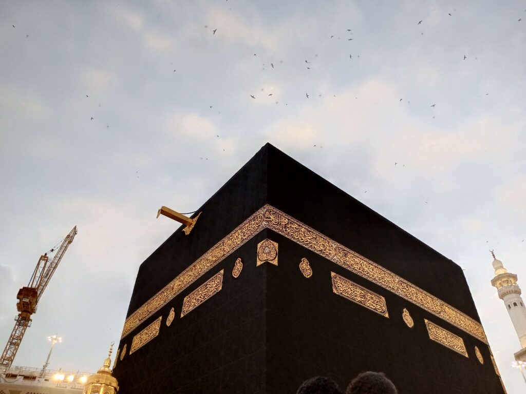 View of the Kaaba at dusk with a clear sky in Mecca, Saudi Arabia.