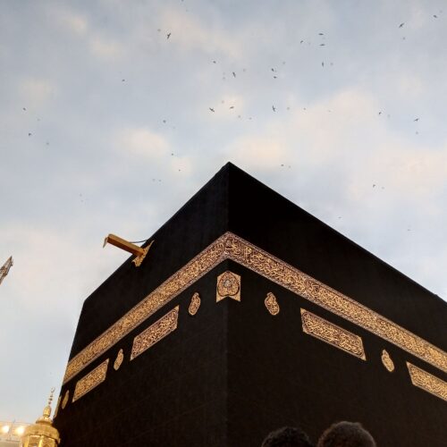 View of the Kaaba at dusk with a clear sky in Mecca, Saudi Arabia.