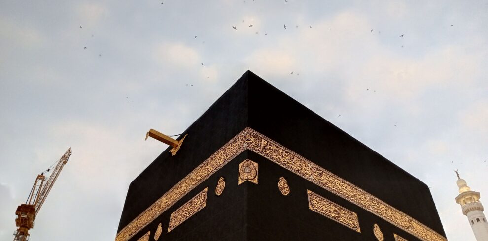 View of the Kaaba at dusk with a clear sky in Mecca, Saudi Arabia.