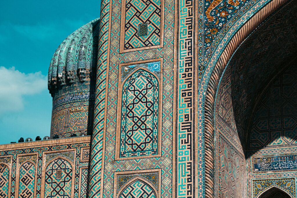 Detailed view of ornate mosaic patterns on Islamic architecture in Uzbekistan, showcasing historic design.