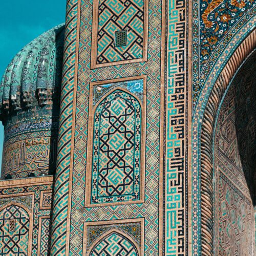 Detailed view of ornate mosaic patterns on Islamic architecture in Uzbekistan, showcasing historic design.