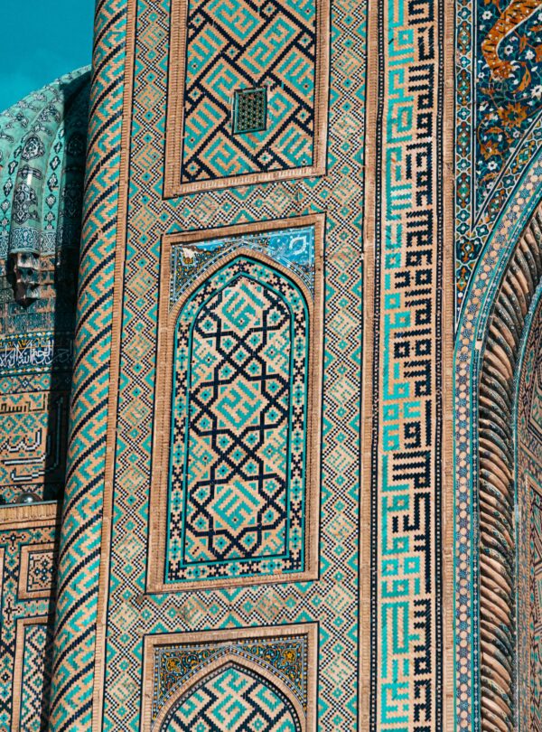 Detailed view of ornate mosaic patterns on Islamic architecture in Uzbekistan, showcasing historic design.