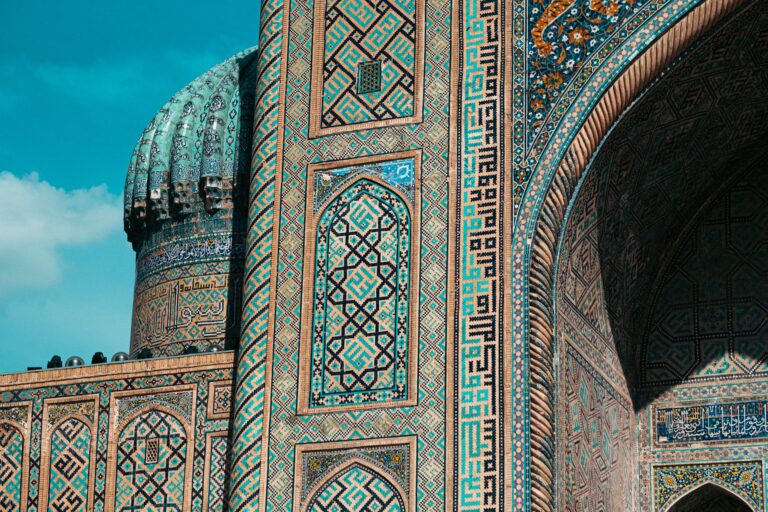 Detailed view of ornate mosaic patterns on Islamic architecture in Uzbekistan, showcasing historic design.
