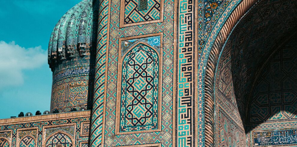 Detailed view of ornate mosaic patterns on Islamic architecture in Uzbekistan, showcasing historic design.