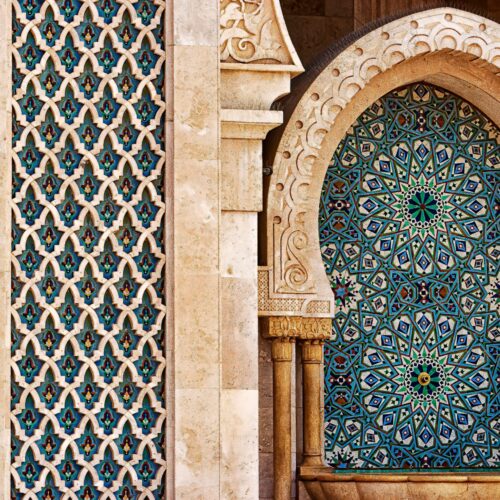 Detailed view of traditional Moorish tilework showcasing intricate patterns and vibrant colors in historic architecture.